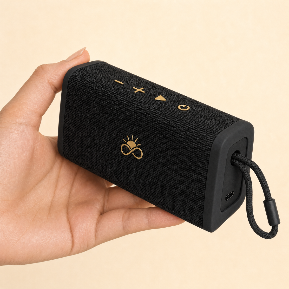 Solfenity Pulse speaker in hand, showing controls and USB-C port