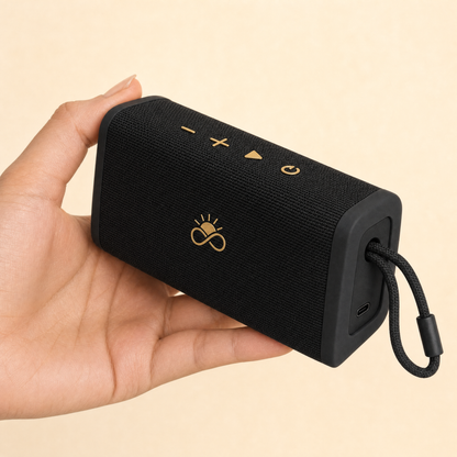 Solfenity Pulse speaker in hand, showing controls and USB-C port